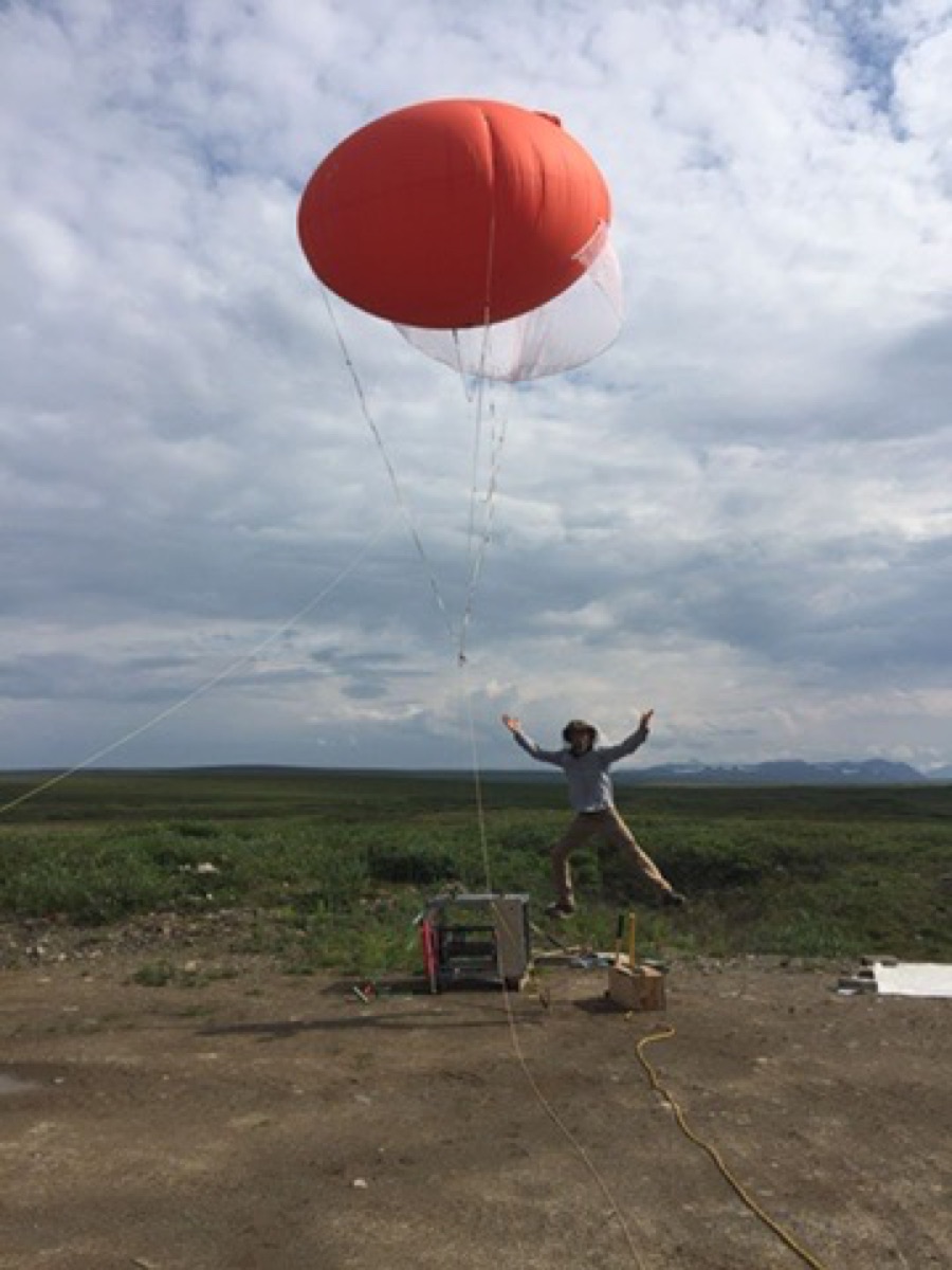 Jumping beneath a tethered research balloon on the Alaskan tundra